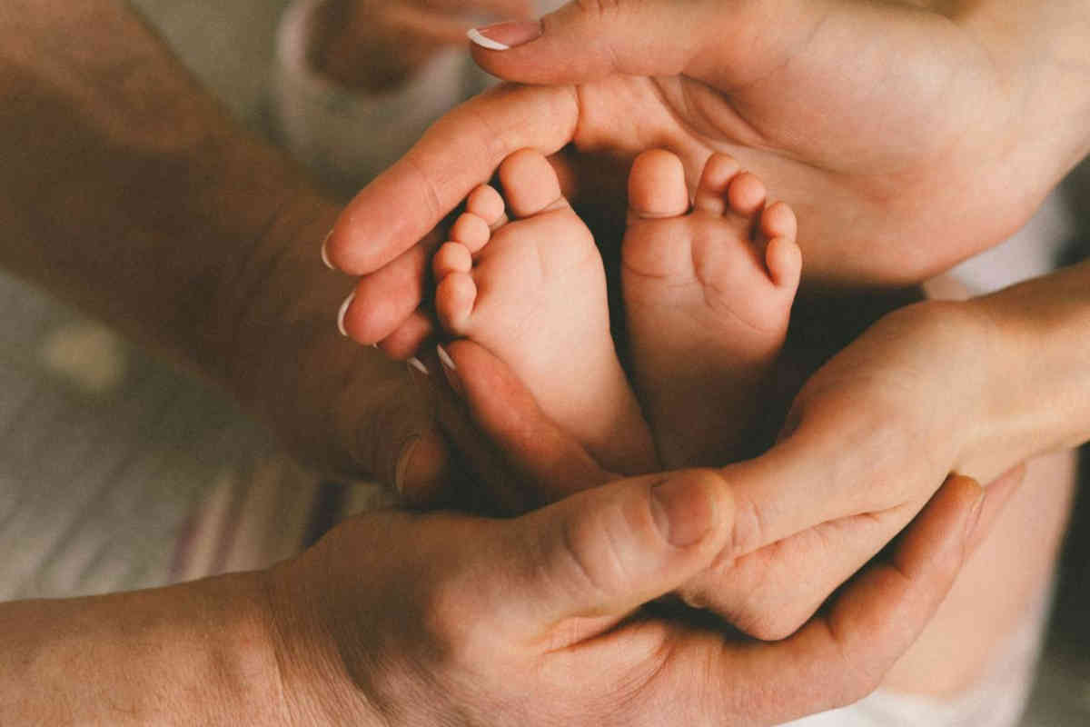 Piedini tra le mani di mamma e papà