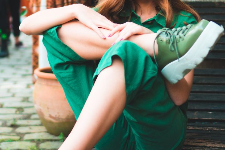 ragazza seduta con outfit verde bottiglia